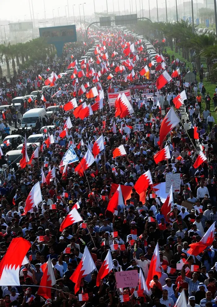 Thousands of Bahrainis in a flag wielding procession.