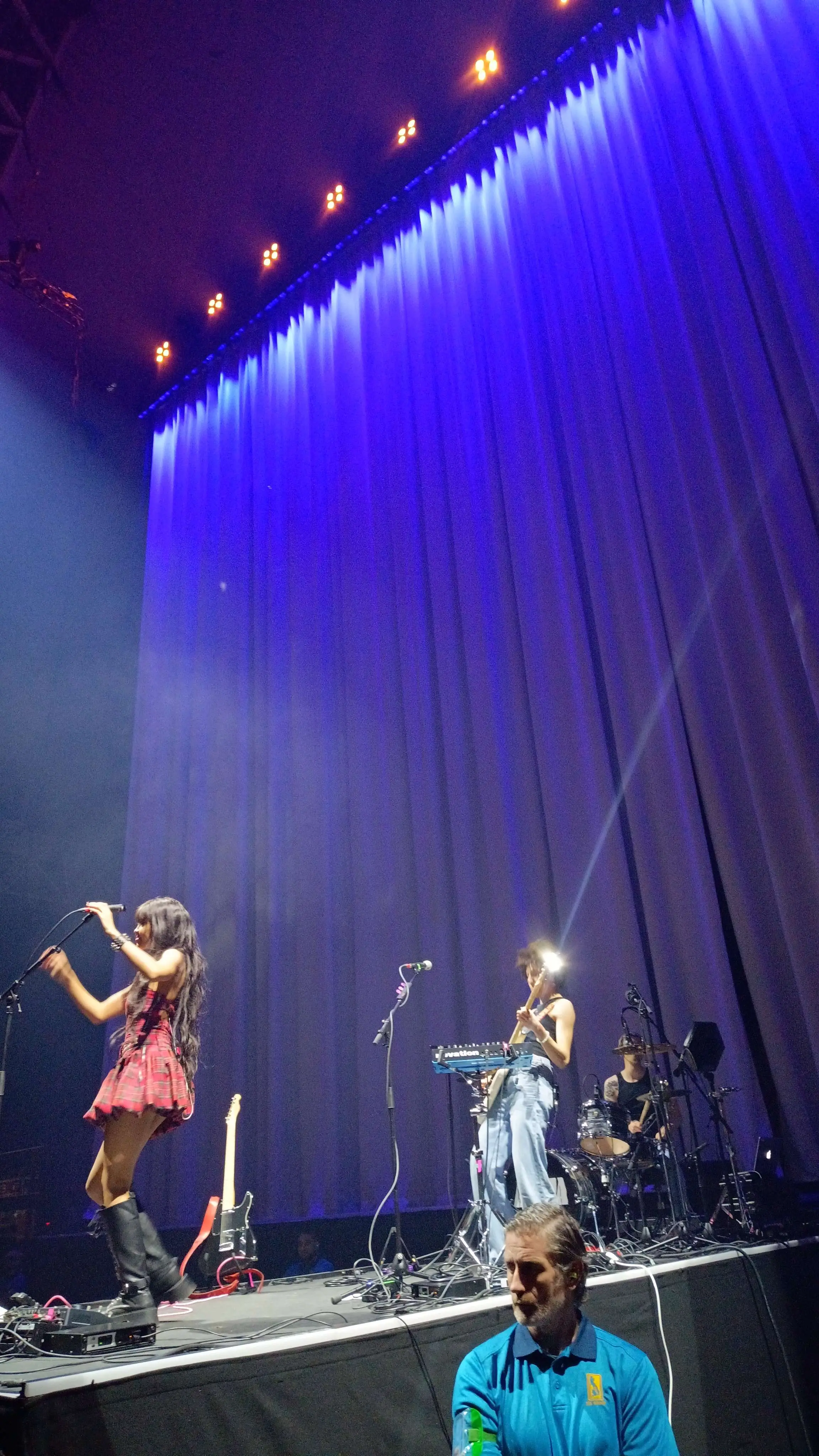 massive venue with gigantic drapes with projections on them