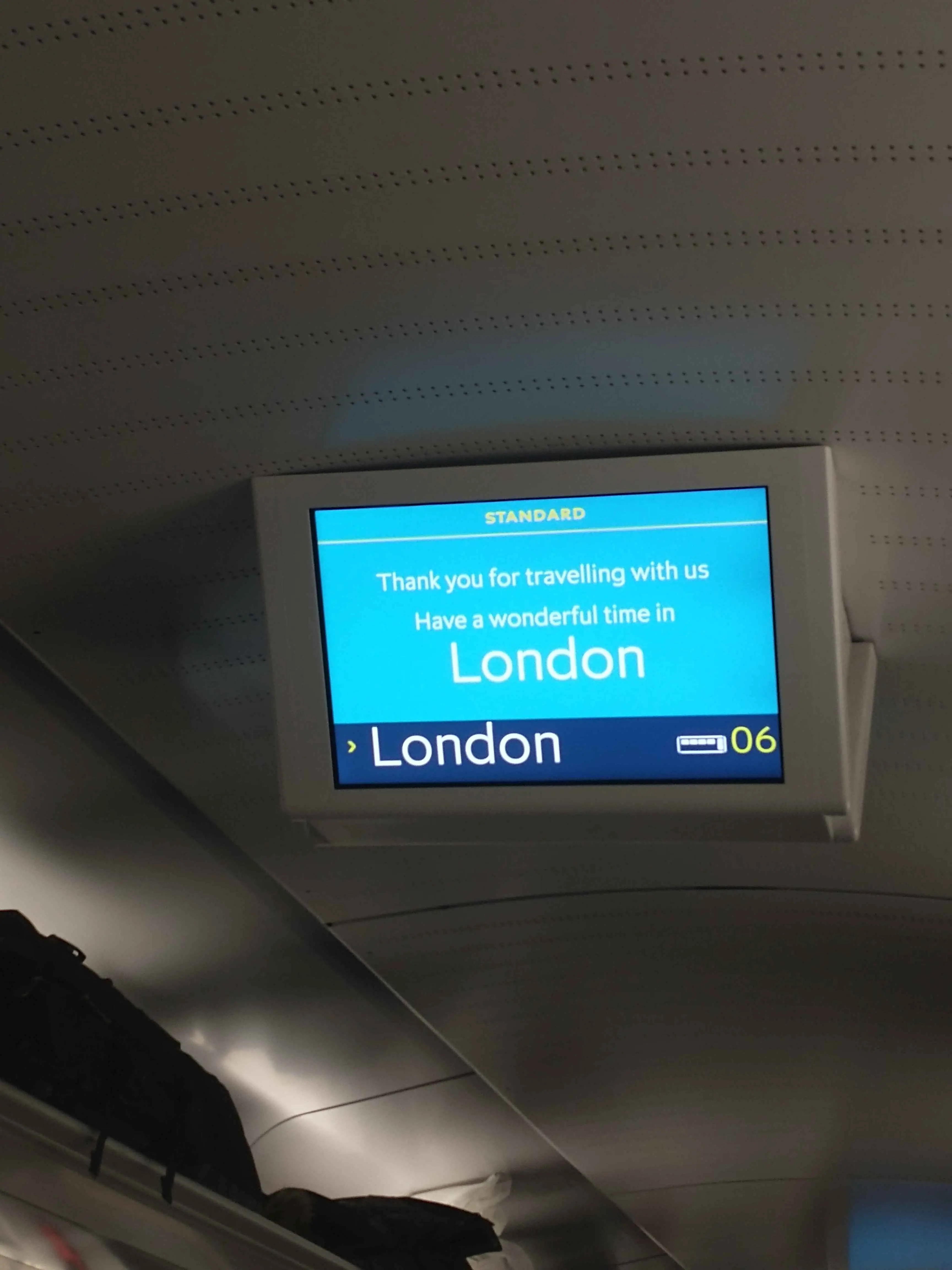 Looking at an info screen in a Eurostar train, welcoming passengers to London.