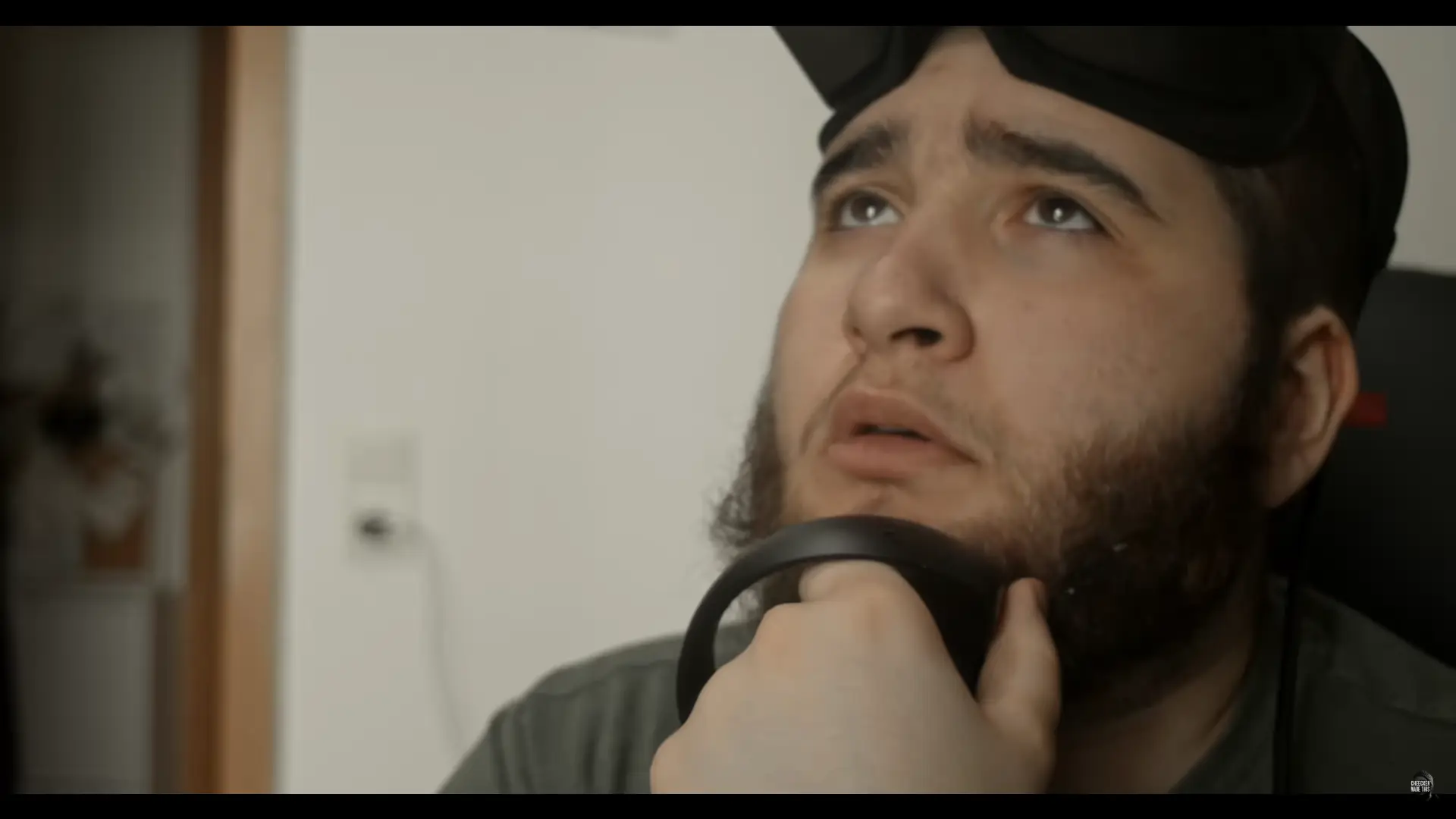 Cheecken is pondering something wearing his VR headset and controllers